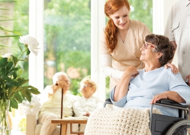 daughter visiting her elderly mother in a retirement home 